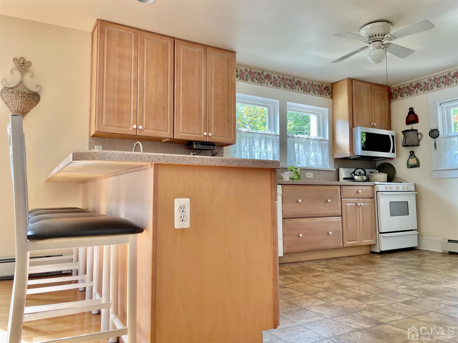 234 Morganville Road Old Bridge, NJ 07747 - Photo 11 of 52 a kitchen with a refrigerator stove and white cabinets