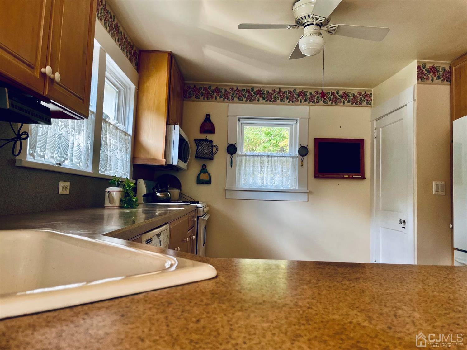 234 Morganville Road Old Bridge, NJ 07747 - Photo 15 of 52 a kitchen with stainless steel appliances granite countertop a sink and a stove