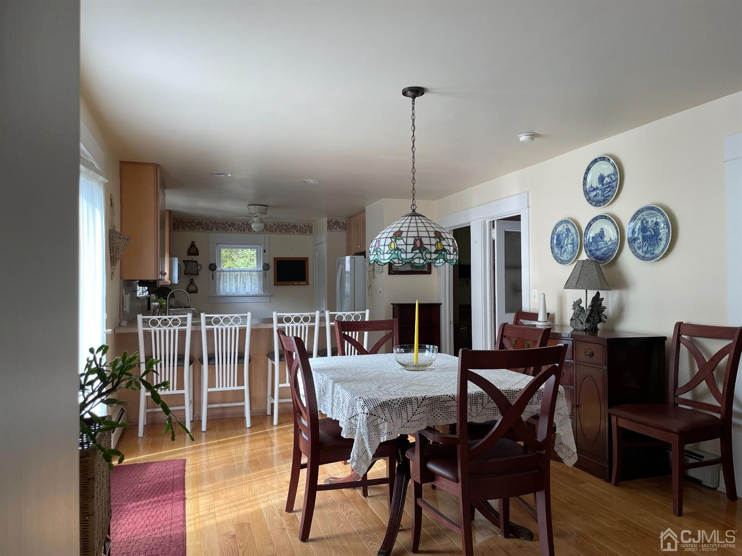 234 Morganville Road Old Bridge, NJ 07747 - Photo 17 of 52 a view of a dining room and livingroom with furniture wooden floor a chandelier