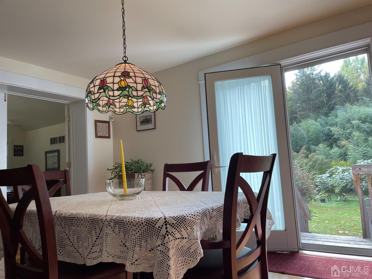 234 Morganville Road Old Bridge, NJ 07747 - Photo 18 of 52 a bedroom with a bed and a chandelier