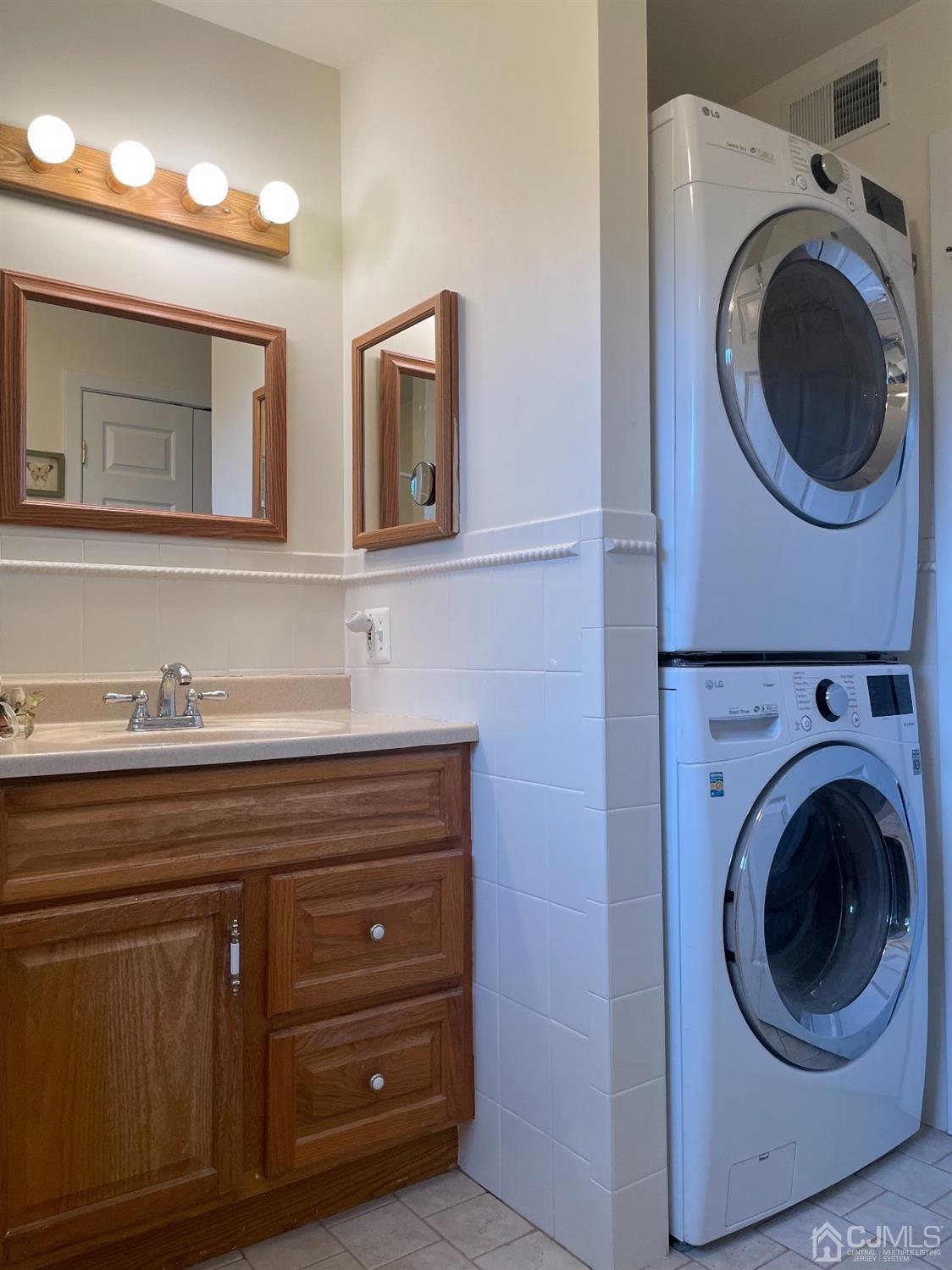 234 Morganville Road Old Bridge, NJ 07747 - Photo 35 of 52 a bathroom with a sink and a washer dryer