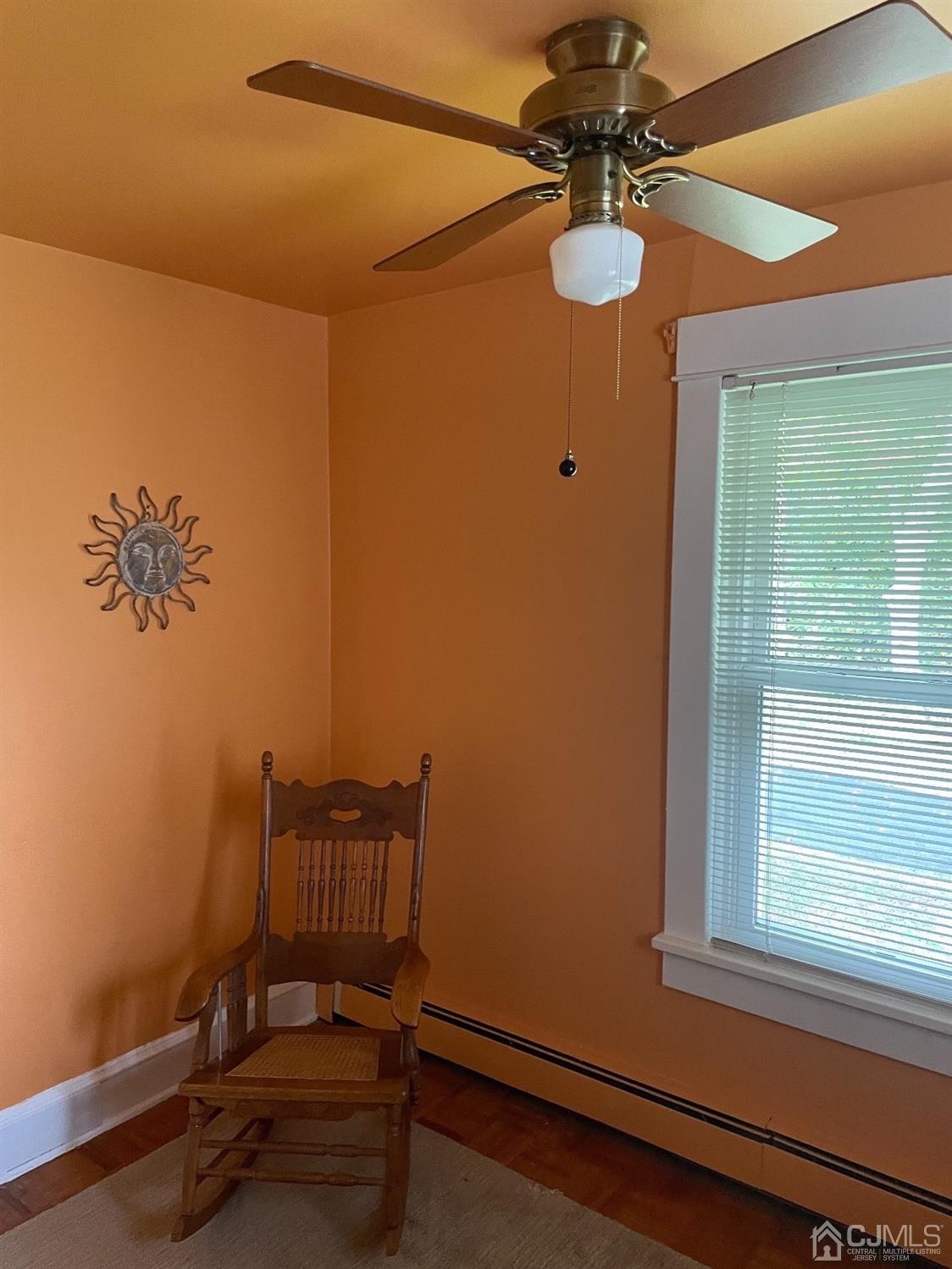 234 Morganville Road Old Bridge, NJ 07747 - Photo 38 of 52 a view of a room with a ceiling fan and wooden floor