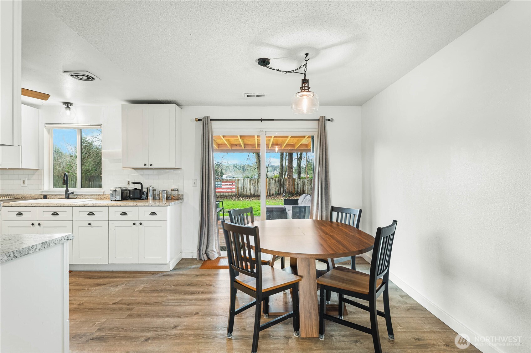 924 9th Street Southwest Puyallup, WA 98371 - Photo 11 of 38 a view of a dining room with furniture window and wooden floor