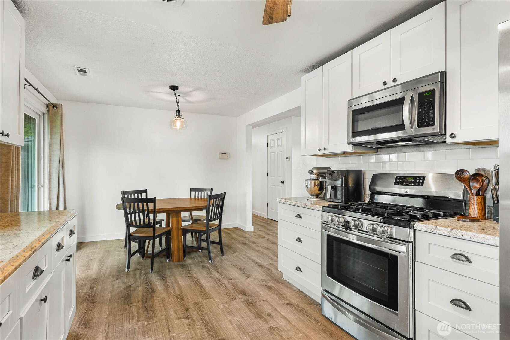 924 9th Street Southwest Puyallup, WA 98371 - Photo 13 of 38 a kitchen with stainless steel appliances a white stove top oven and cabinets