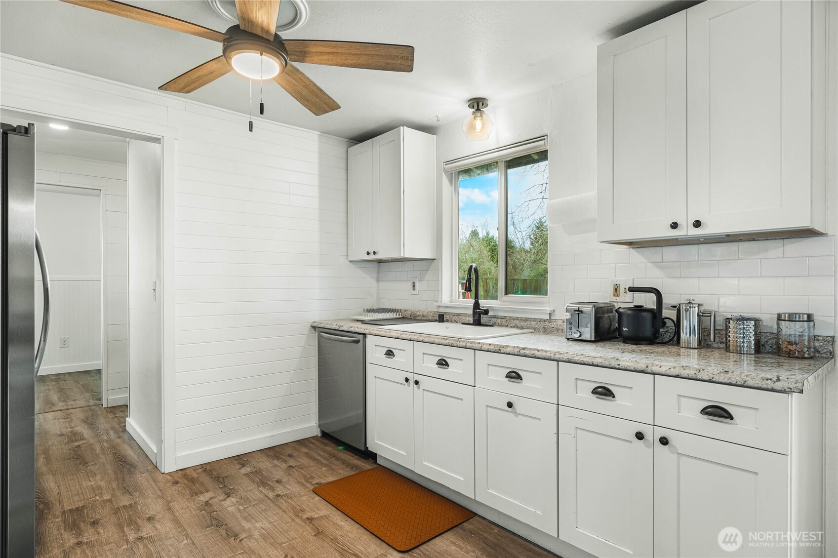 924 9th Street Southwest Puyallup, WA 98371 - Photo 14 of 38 a kitchen with stainless steel appliances white cabinets and a window