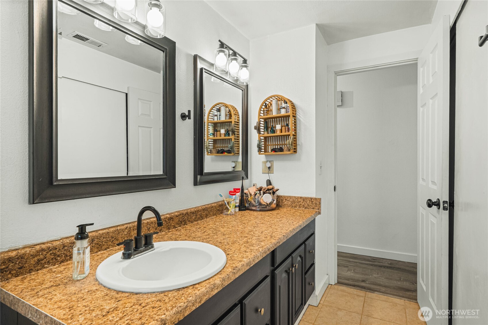 924 9th Street Southwest Puyallup, WA 98371 - Photo 20 of 38 a bathroom with a granite countertop sink and a mirror