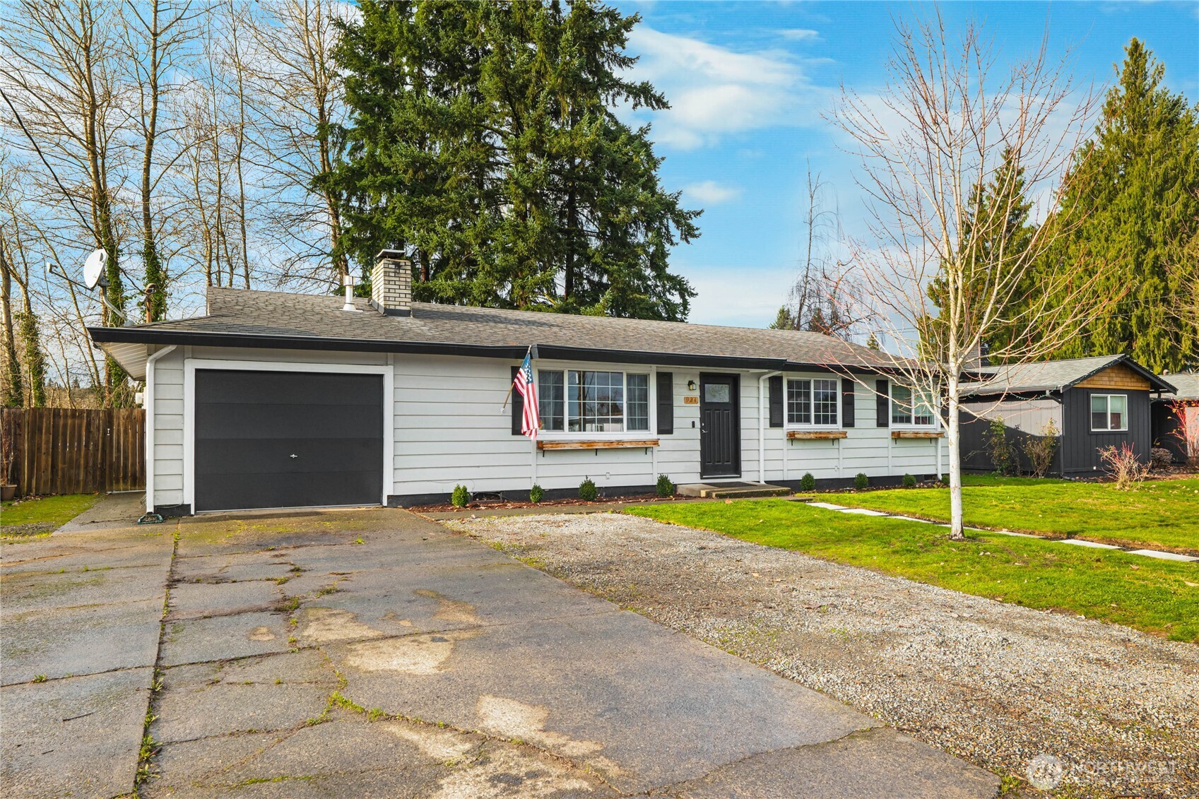 924 9th Street Southwest Puyallup, WA 98371 - Photo 2 of 38 a front view of a house with a yard and trees