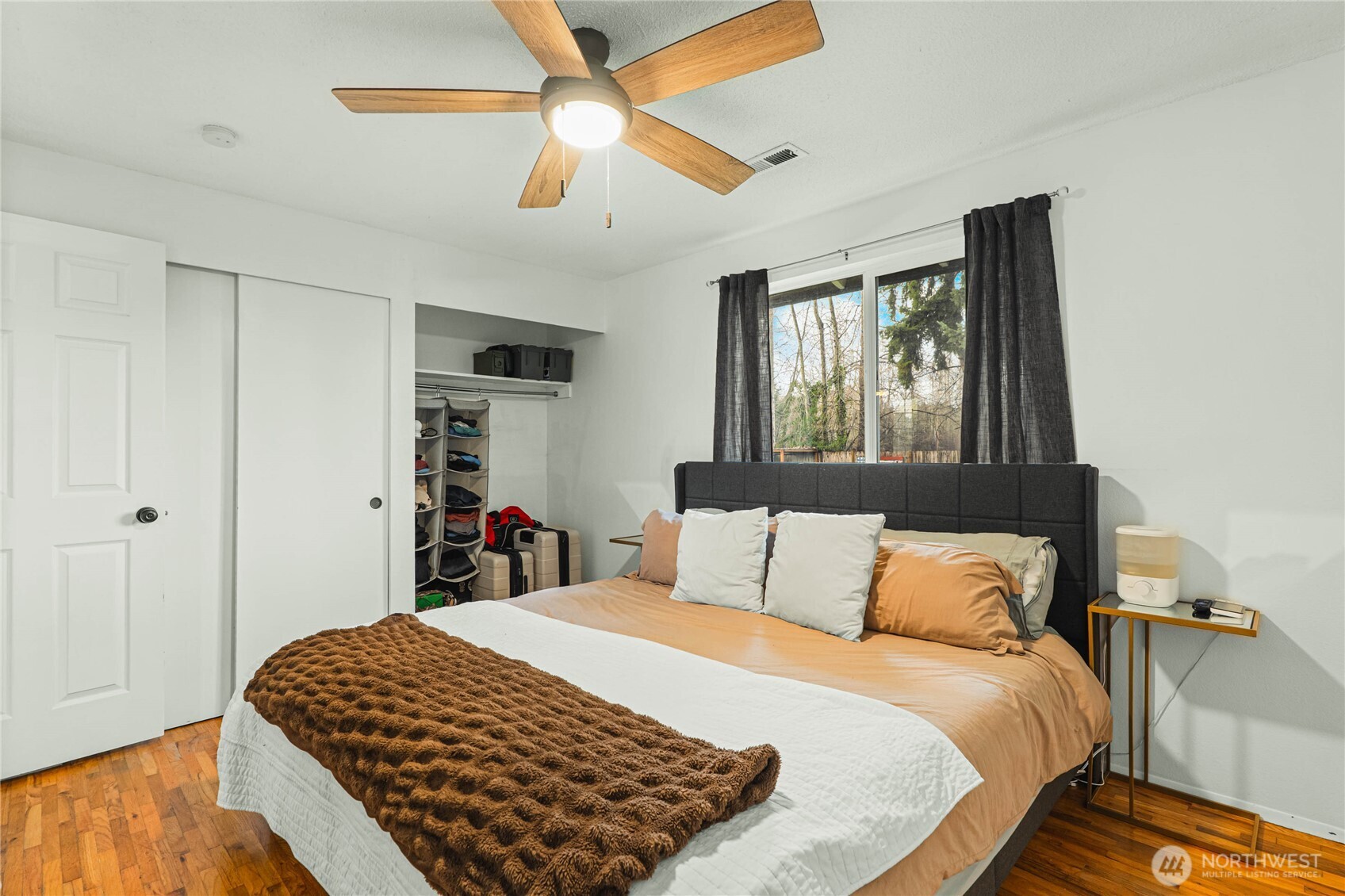 924 9th Street Southwest Puyallup, WA 98371 - Photo 21 of 38 a bedroom with a bed and a chandelier