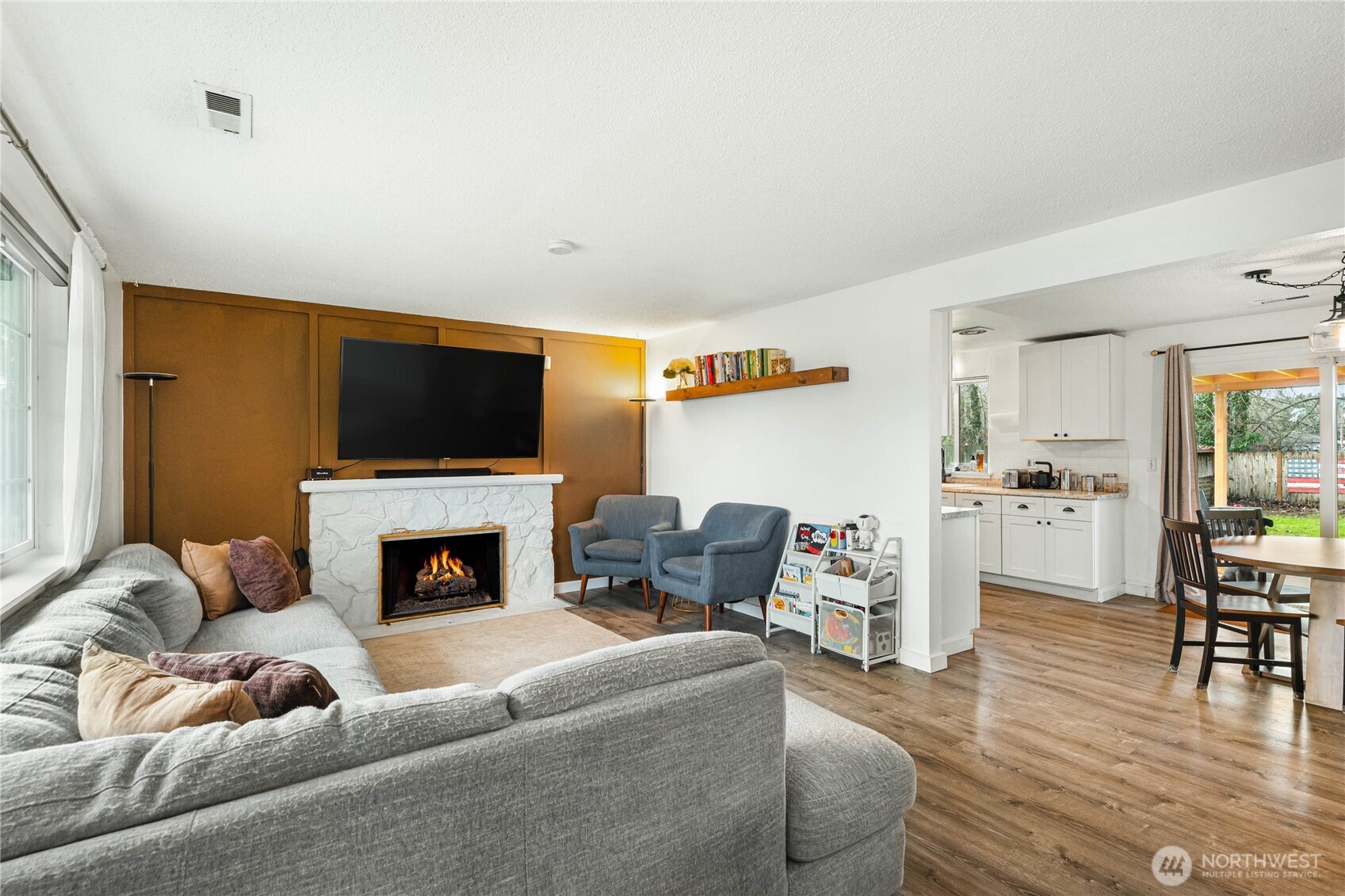 924 9th Street Southwest Puyallup, WA 98371 - Photo 7 of 38 a living room with furniture a fireplace and a flat screen tv