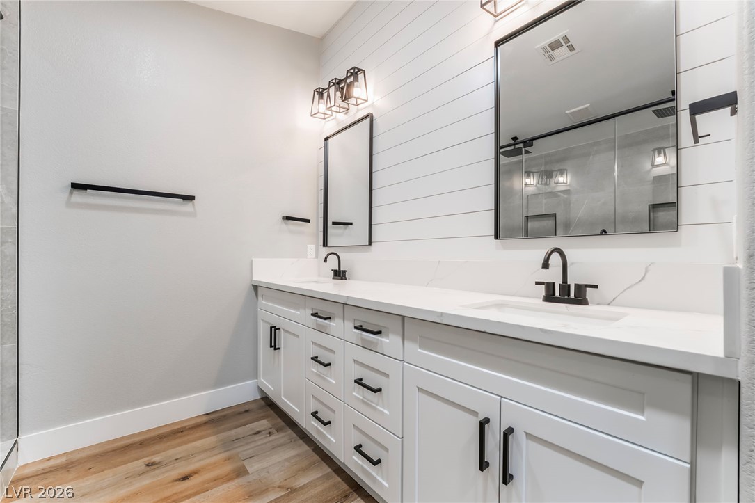 9171 West Viking Road Las Vegas, NV 89147 - Photo 35 of 43 Double vanities with quartz countertops and modern fixtures create a refreshing bathroom space.