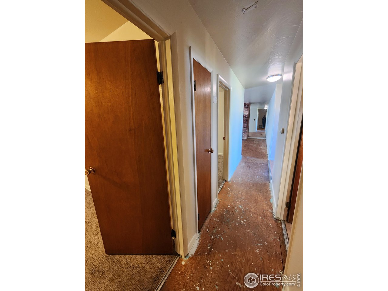 1107 Delmar Street Sterling, CO 80751 - Photo 13 of 49 a view of a hallway with wooden floor