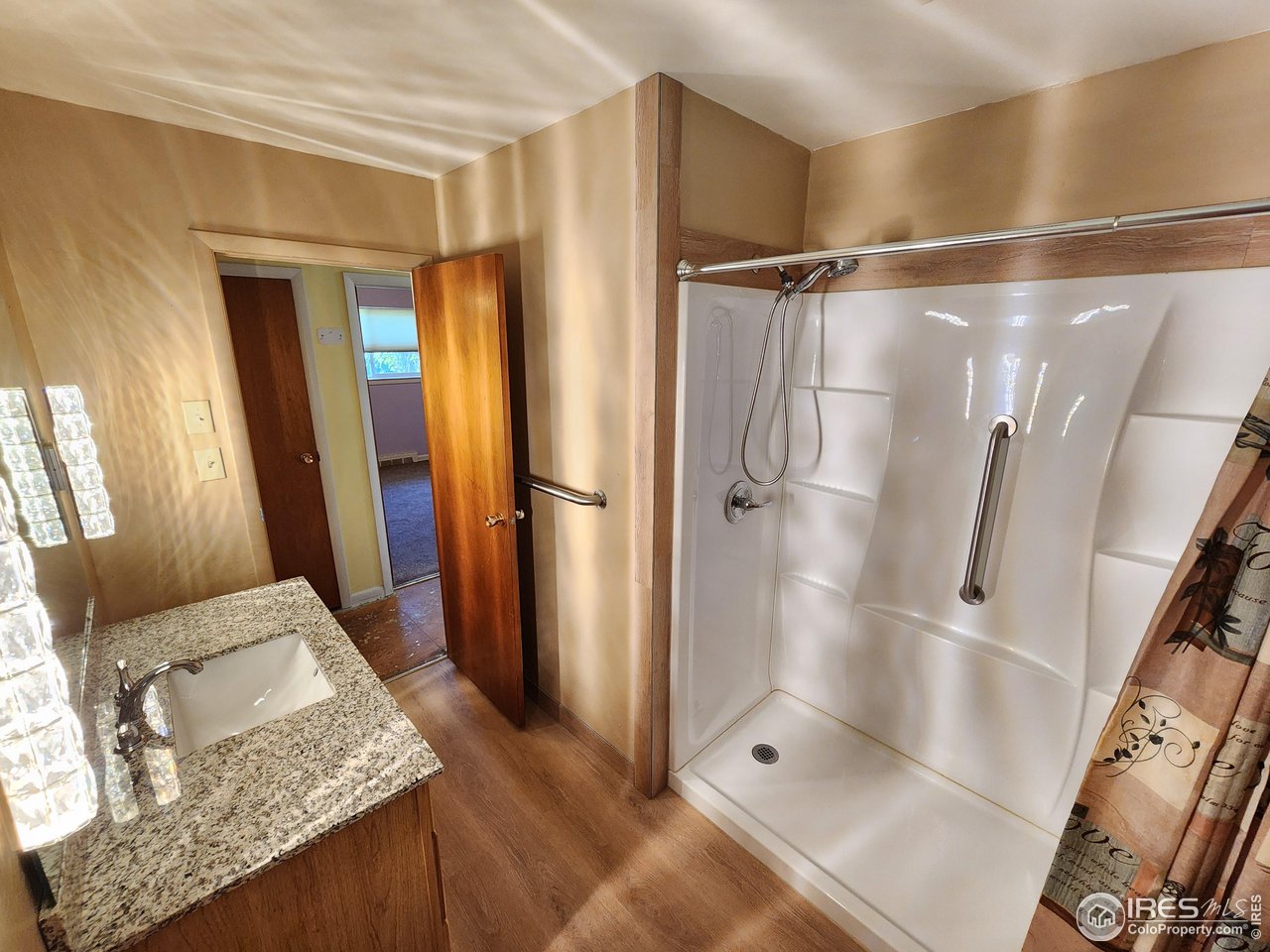 1107 Delmar Street Sterling, CO 80751 - Photo 15 of 49 a bathroom with a granite countertop shower and a sink