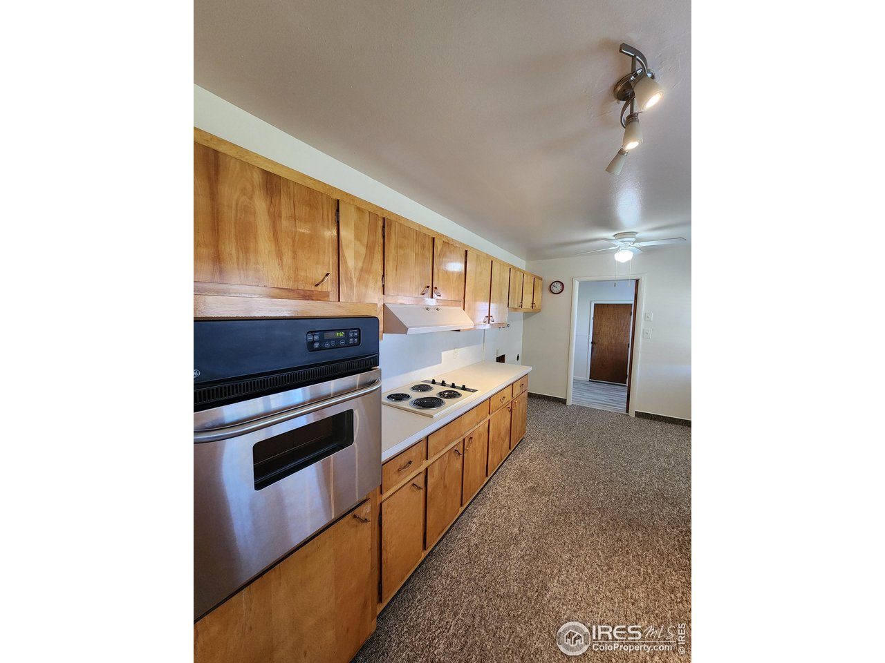 1107 Delmar Street Sterling, CO 80751 - Photo 18 of 49 a kitchen with stainless steel appliances granite countertop a stove and a refrigerator
