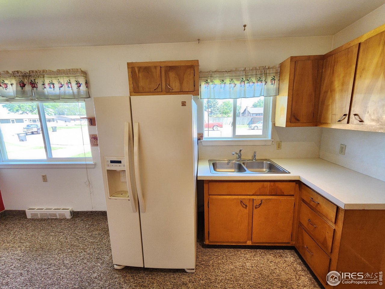 1107 Delmar Street Sterling, CO 80751 - Photo 20 of 49 a kitchen with a refrigerator and window