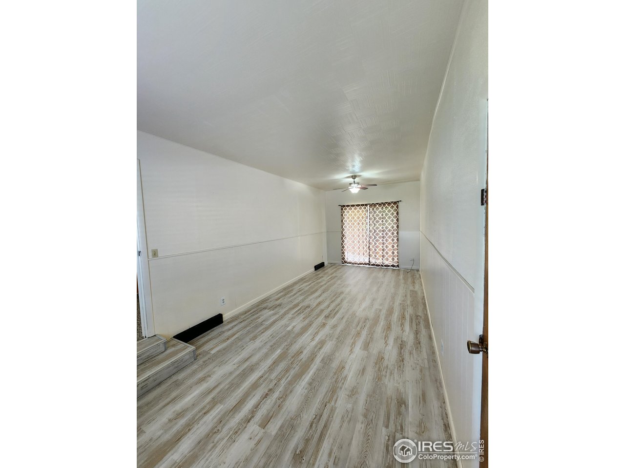 1107 Delmar Street Sterling, CO 80751 - Photo 23 of 49 a view of a room with wooden floor