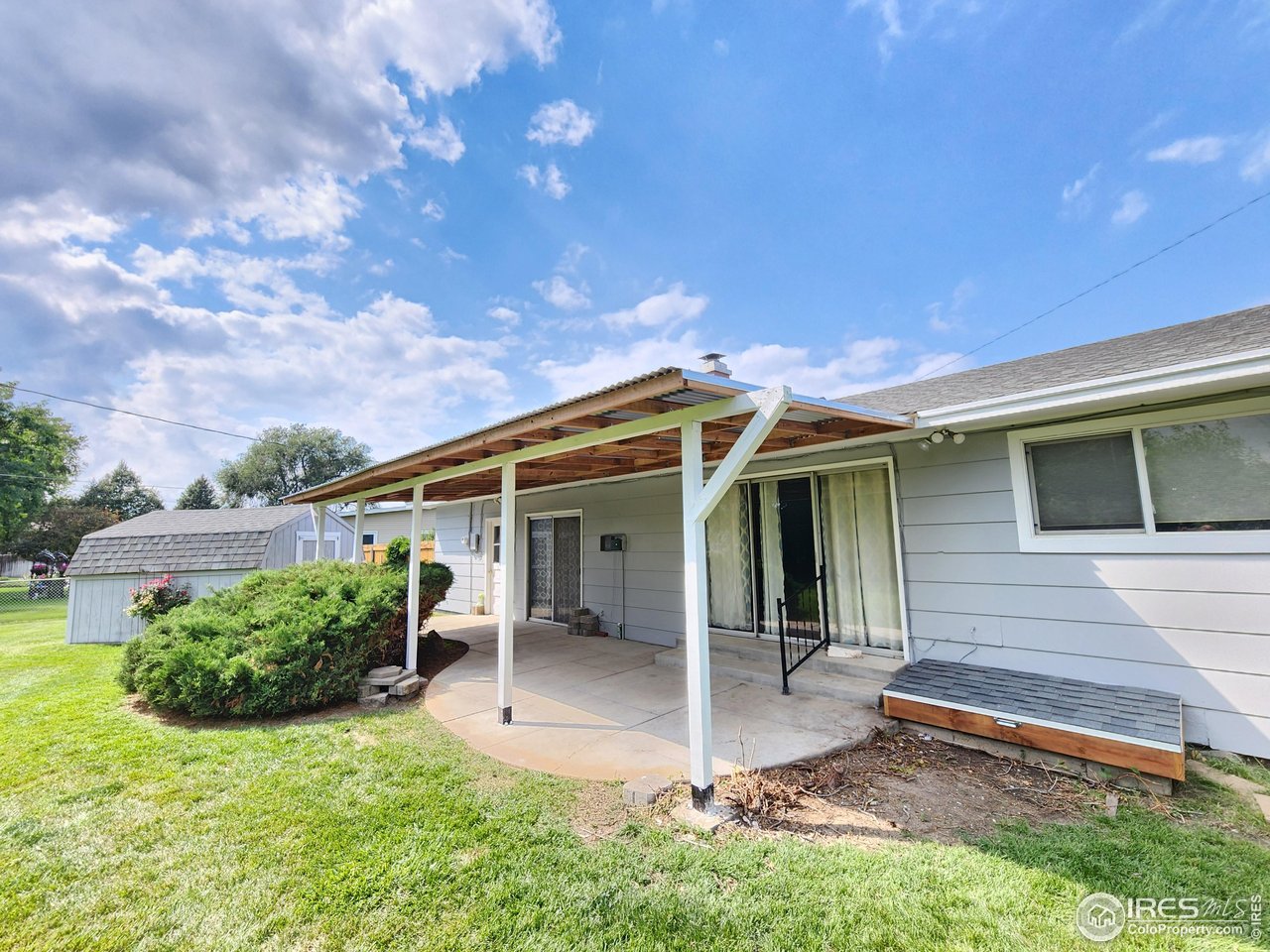 1107 Delmar Street Sterling, CO 80751 - Photo 26 of 49 a backyard of a house with yard table and chairs