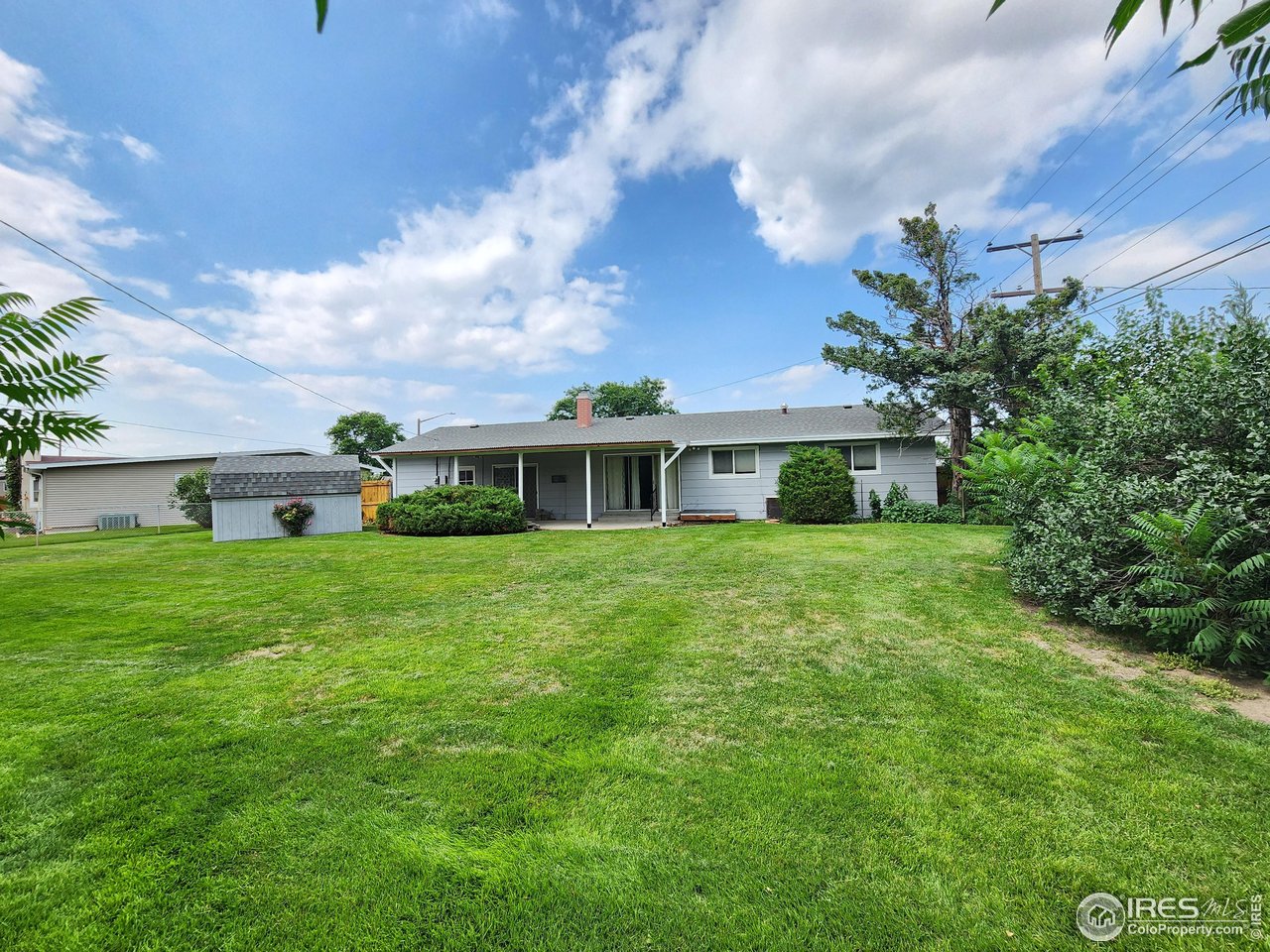 1107 Delmar Street Sterling, CO 80751 - Photo 27 of 49 a front view of a house with a yard