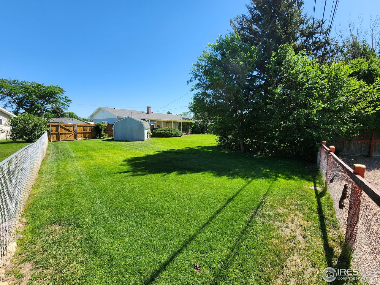 1107 Delmar Street Sterling, CO 80751 - Photo 30 of 49 a view of a backyard with sitting area