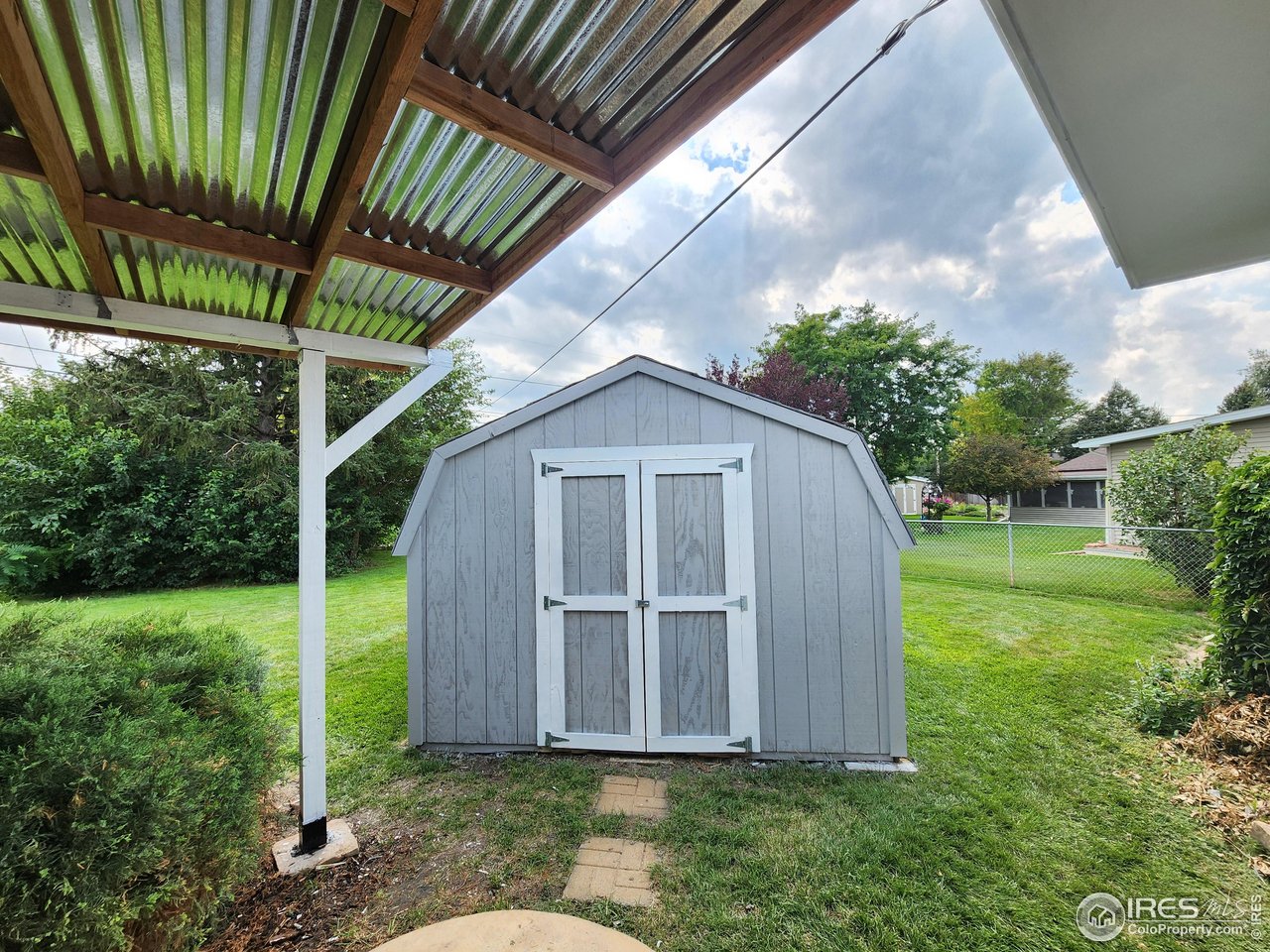 1107 Delmar Street Sterling, CO 80751 - Photo 33 of 49 a front view of a house with garden