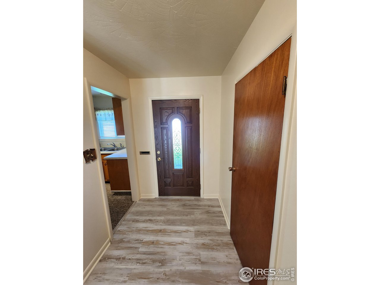 1107 Delmar Street Sterling, CO 80751 - Photo 44 of 49 a view of a hallway with wooden floor