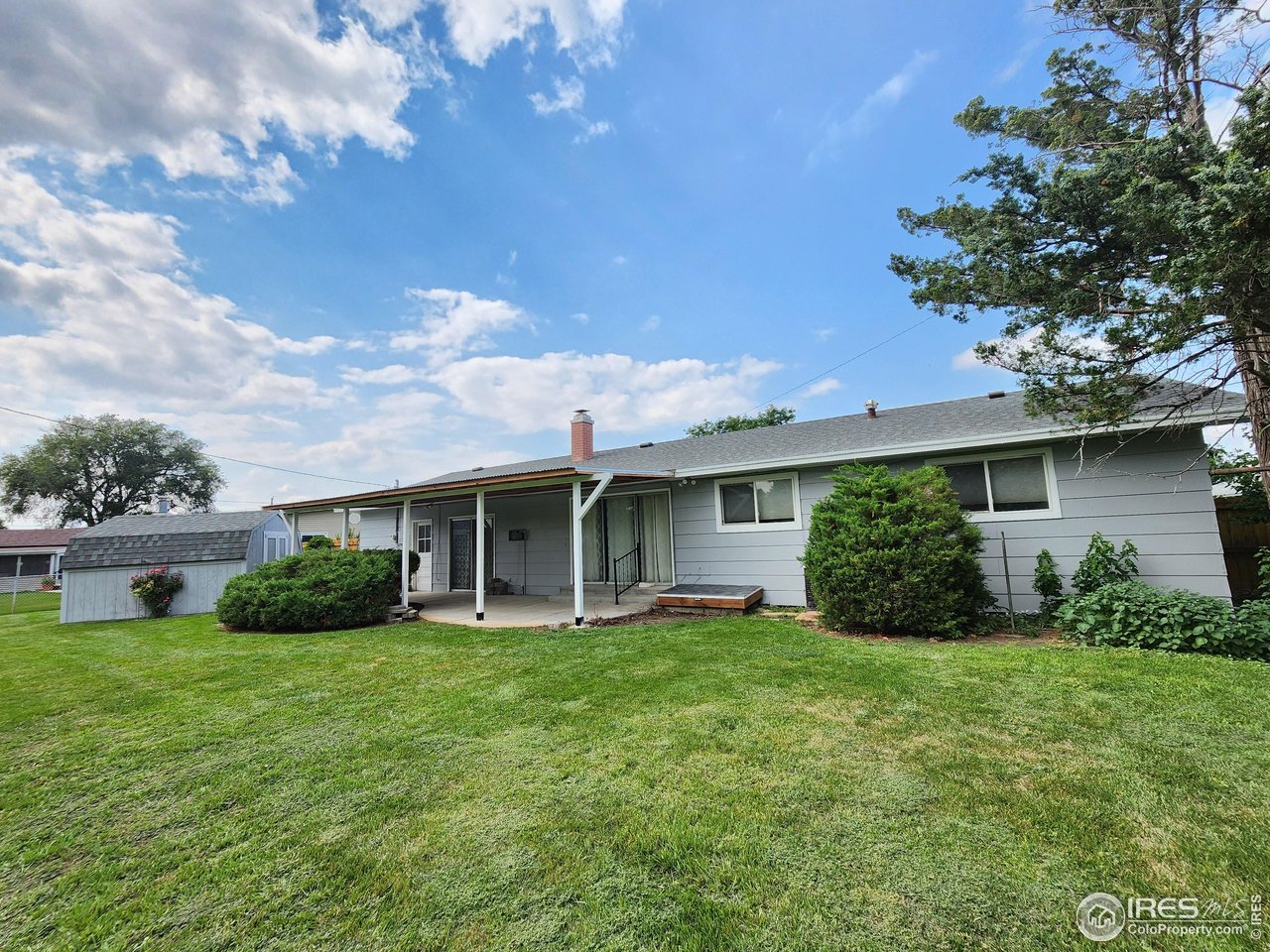 1107 Delmar Street Sterling, CO 80751 - Photo 46 of 49 a view of a house with porch and garden