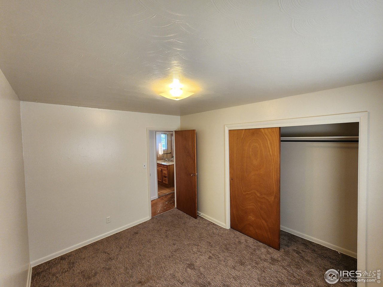 1107 Delmar Street Sterling, CO 80751 - Photo 10 of 49 an empty room with closet area