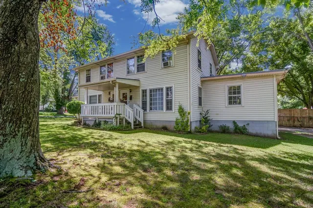 a view of a house with a yard and plants