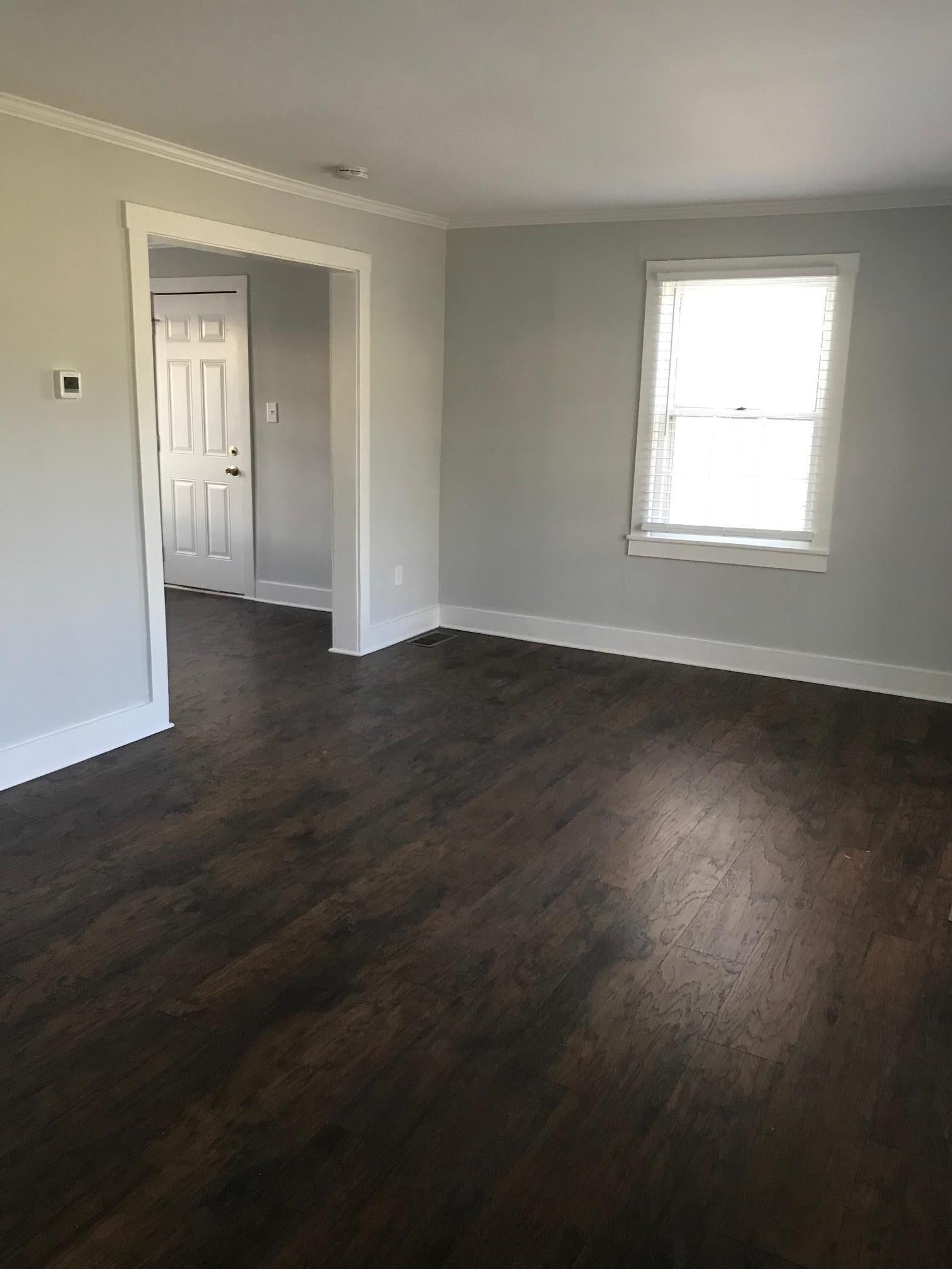 1401 8th Street Old Hickory, TN 37138 - Photo 6 of 14 an empty room with wooden floor and windows