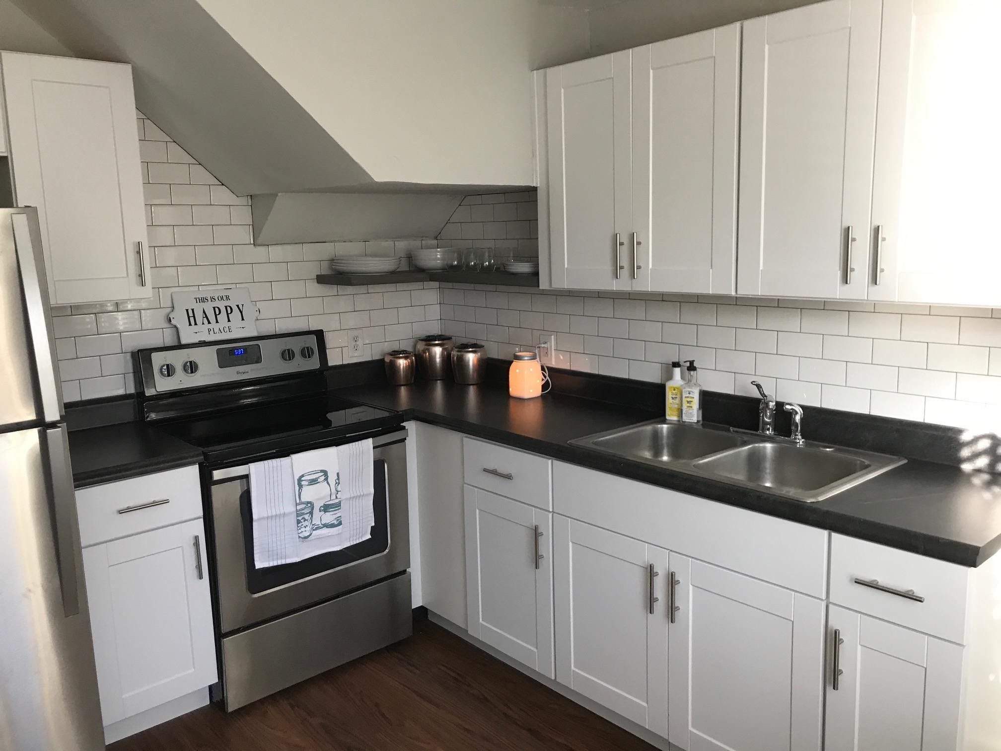 1401 8th Street Old Hickory, TN 37138 - Photo 7 of 14 a kitchen with granite countertop white cabinets and sink