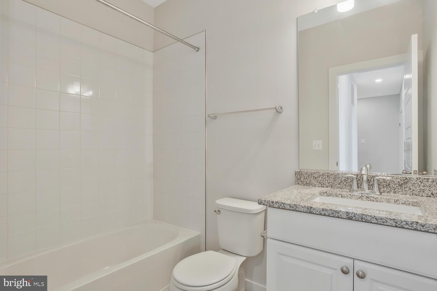 302 Summit Point Boulevard Bowie, MD 20716 - Photo 21 of 30 a bathroom with a granite countertop sink toilet and shower