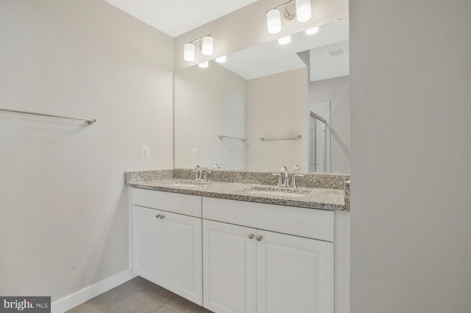 302 Summit Point Boulevard Bowie, MD 20716 - Photo 10 of 30 a bathroom with a granite countertop sink and a mirror