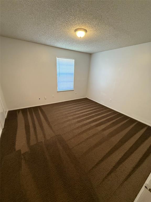 1708 Short Street, Unit B Cleburne, TX 76033 - Photo 6 of 8 Spacious room featuring brown carpeting, white walls, and a single window with blinds