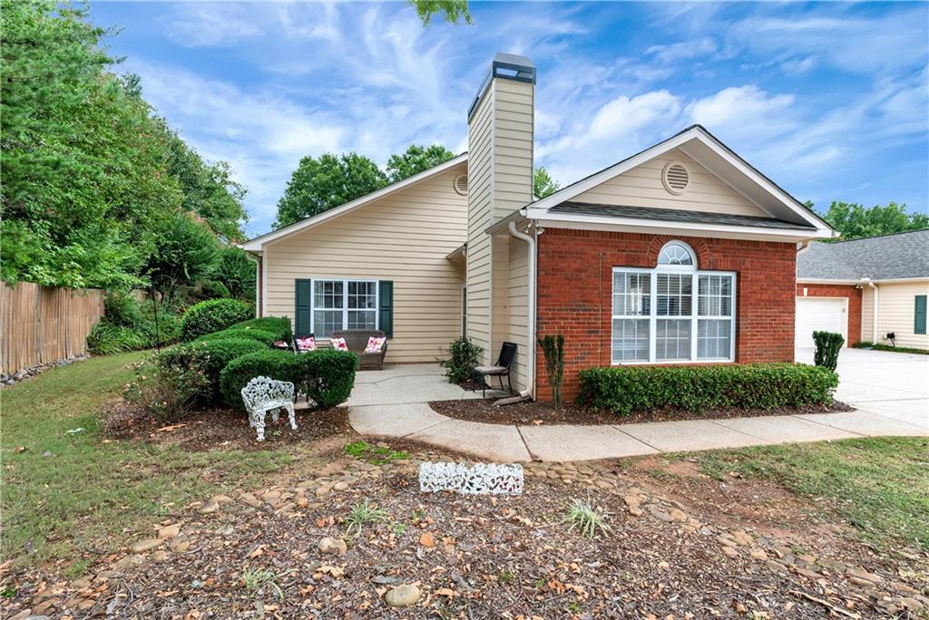 460 Tribble Gap Road, Unit 104 Cumming, GA 30040 - Photo 1 of 1 a front view of house with yard and green space