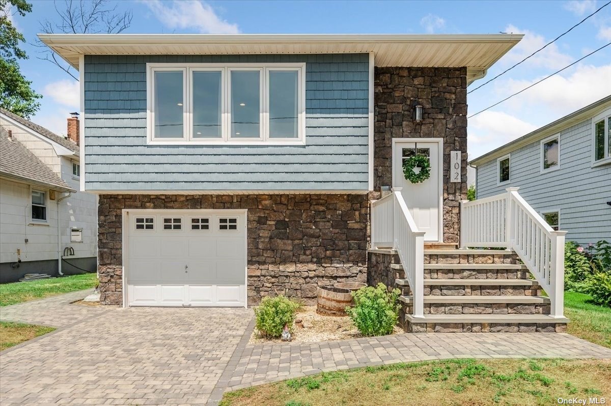 102 N Road Babylon, NY 11702 - Photo 1 of 1 a front view of a house with a yard and garage