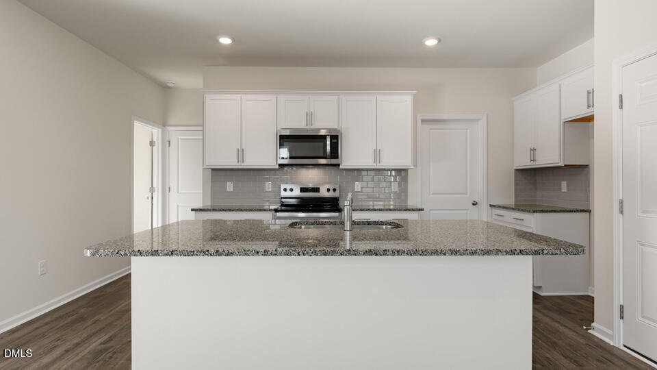 433 Hvn Hl Road Hillsborough, NC 27278 - Photo 5 of 33 a kitchen with granite countertop a sink a stove a microwave a refrigerator a microwave and cabinets
