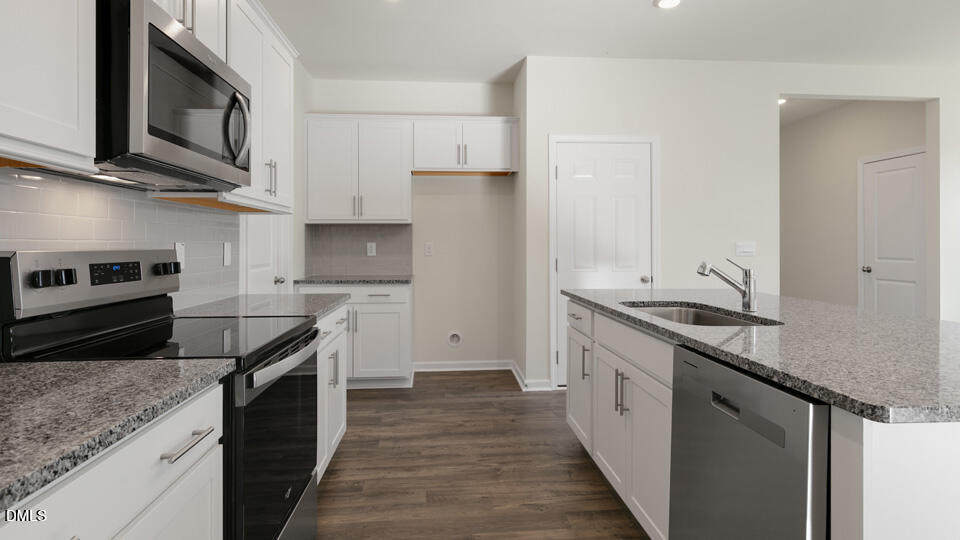 433 Hvn Hl Road Hillsborough, NC 27278 - Photo 7 of 33 a kitchen with stainless steel appliances granite countertop a stove a sink and a microwave