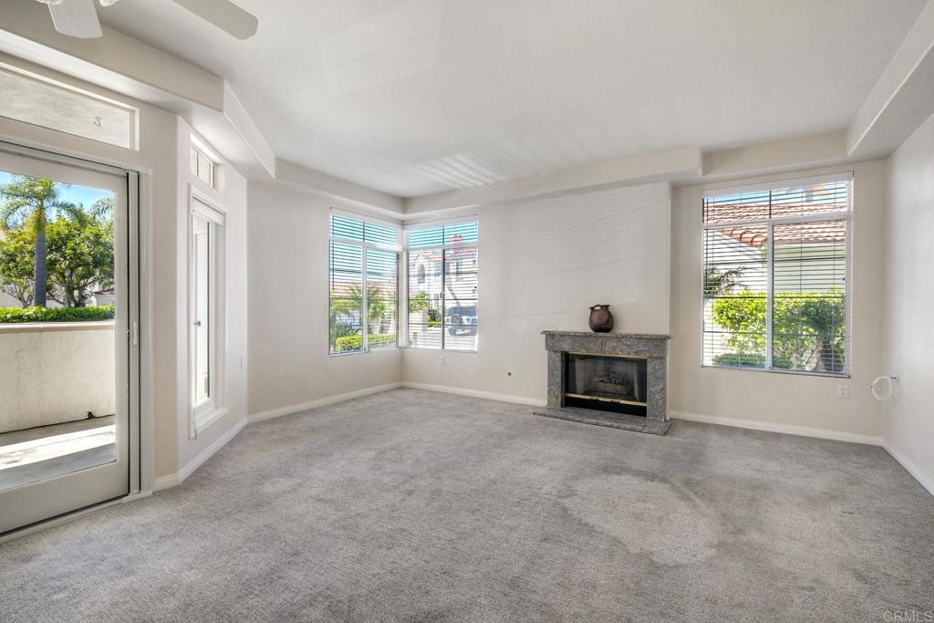 3375 Genoa Way, Unit 144 Oceanside, CA 92056 - Photo 5 of 34 Bright living room with a cozy fireplace