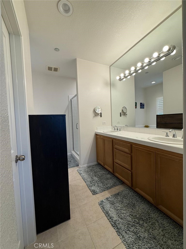 2931 Esperanza Way, Unit B Simi Valley, CA 93063 - Photo 27 of 49 a spacious bathroom with a double vanity sink and a mirror