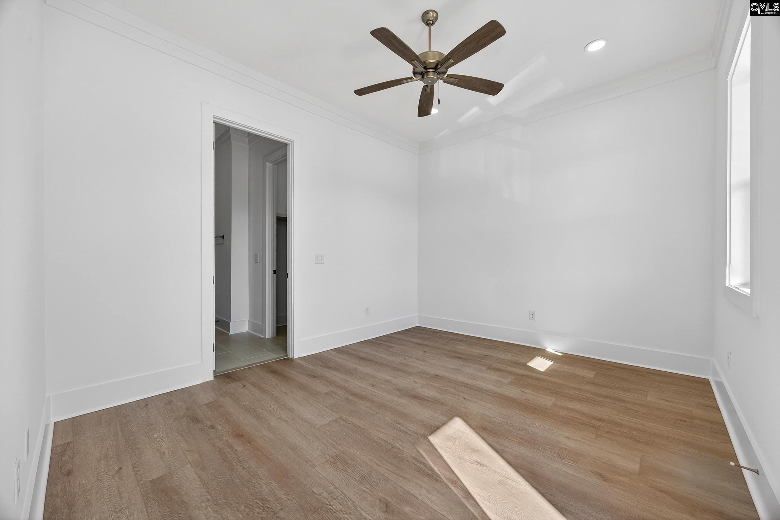 1318 Long Grove Way Lexington, SC 29072 - Photo 64 of 90 an empty room with wooden floor and windows