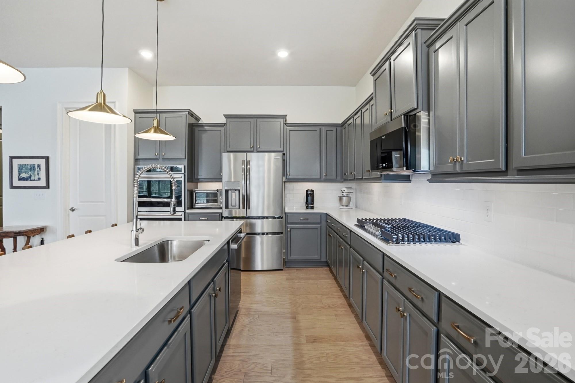 4012 Pollock View Mount Mount Holly, NC 28120 - Photo 12 of 48 a kitchen with stainless steel appliances granite countertop a sink and a refrigerator
