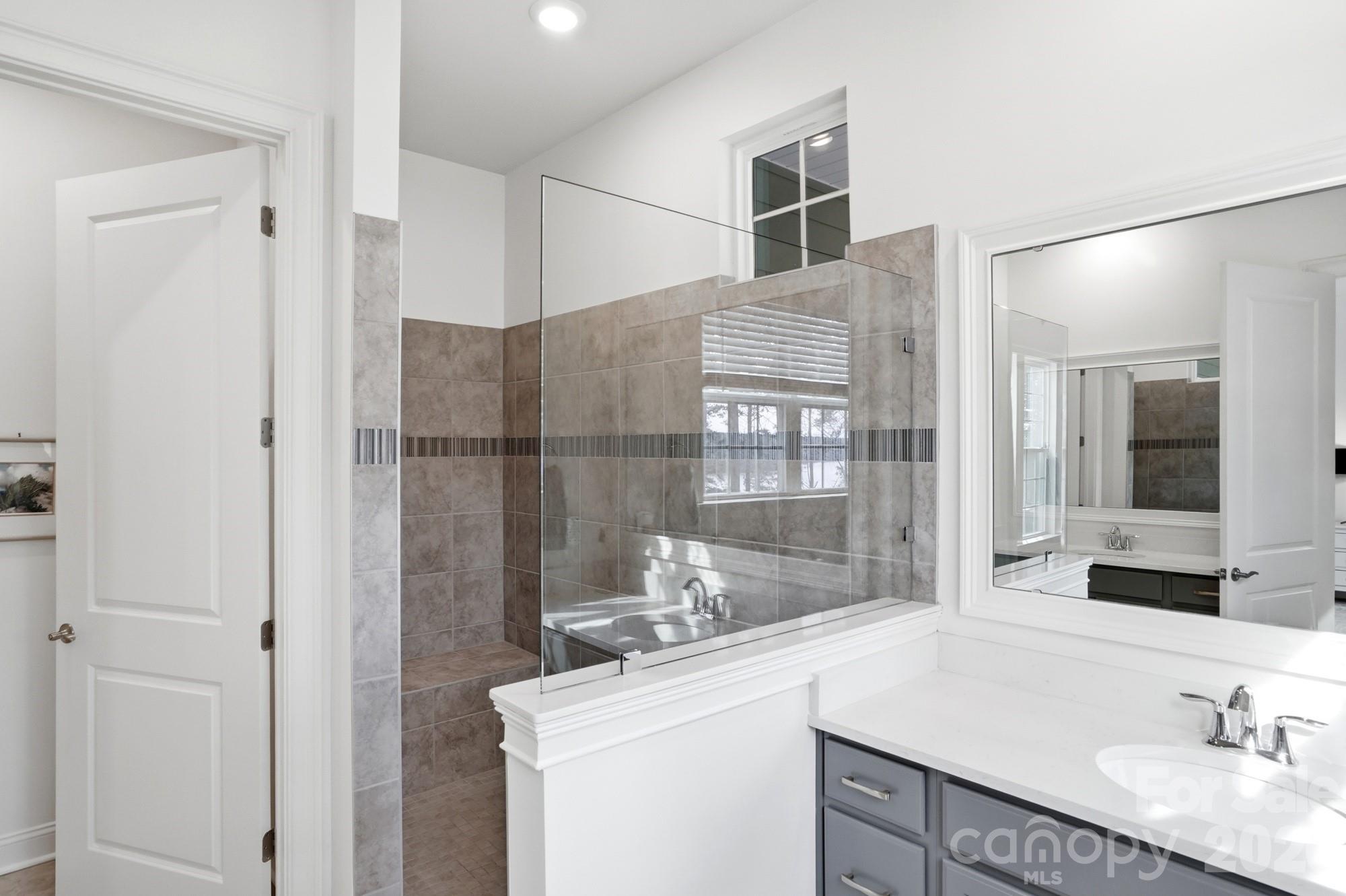 4012 Pollock View Mount Mount Holly, NC 28120 - Photo 19 of 48 a bathroom with a granite countertop sink mirror and double