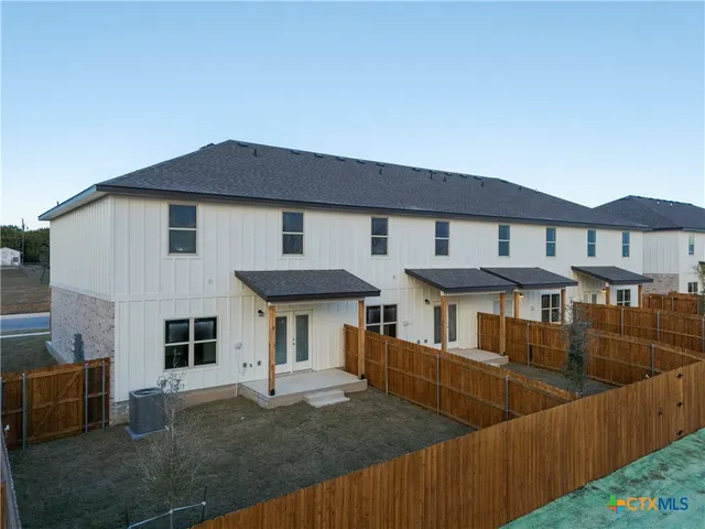 a front view of house with a garden
