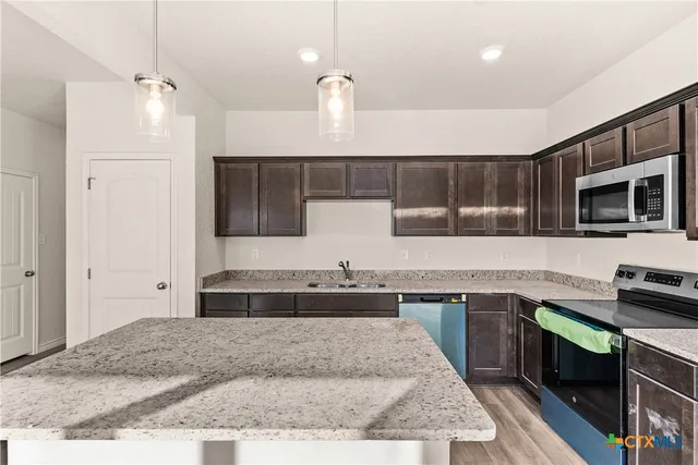 a kitchen with a stove and a sink