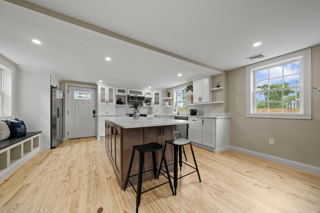 162 High Street, Unit B Danvers, MA 01923 - Photo 8 of 32 a kitchen with a table and chairs in it