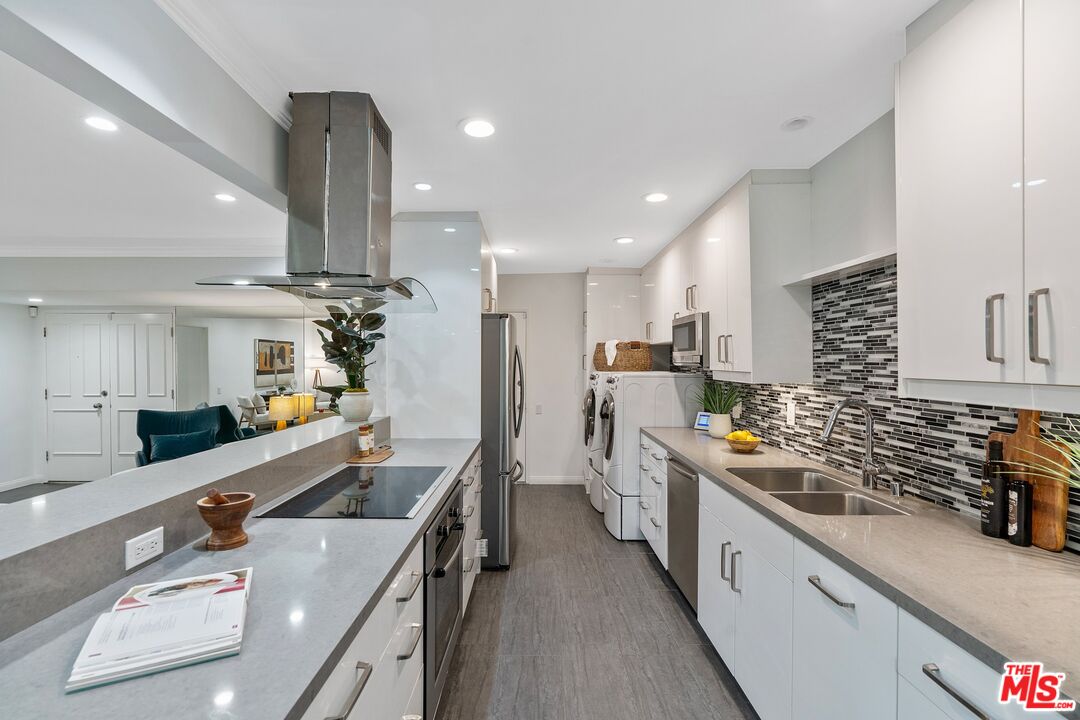 1015 North Kings Road, Unit 110 West Hollywood, CA 90069 - Photo 13 of 38 a large kitchen with stainless steel appliances lots of counter space and a sink