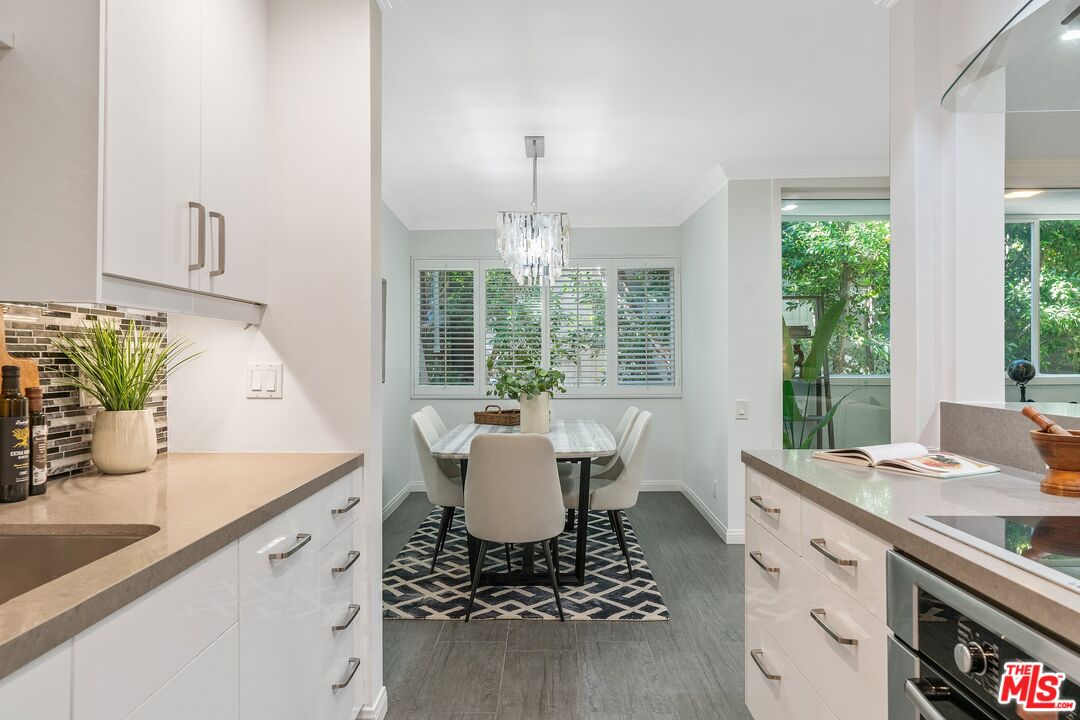 1015 North Kings Road, Unit 110 West Hollywood, CA 90069 - Photo 15 of 38 a dining room with a sink dishwasher and a large window