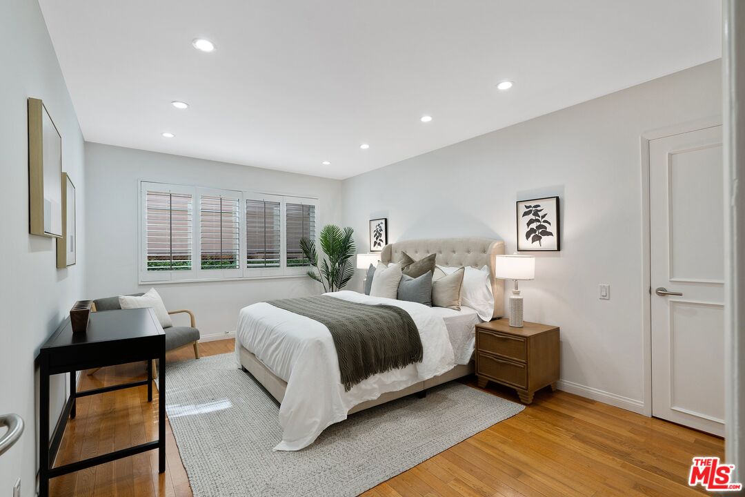 1015 North Kings Road, Unit 110 West Hollywood, CA 90069 - Photo 27 of 38 a spacious bedroom with a bed and a window