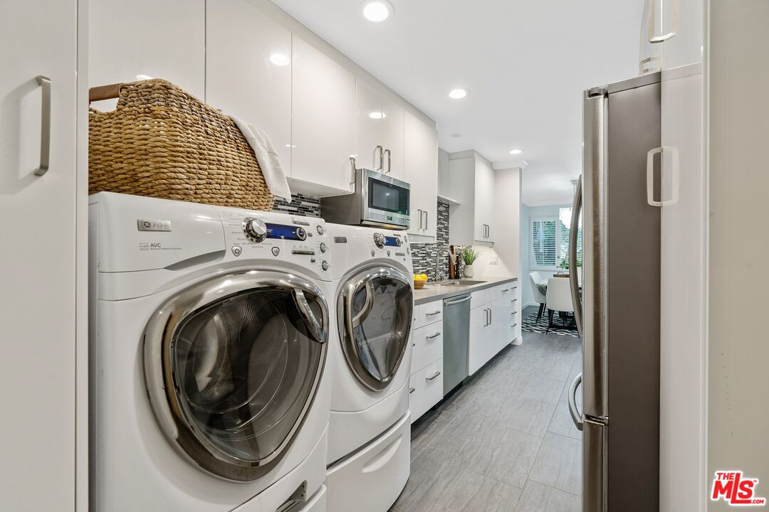 1015 North Kings Road, Unit 110 West Hollywood, CA 90069 - Photo 33 of 38 a view of kitchen sink and washer dryer
