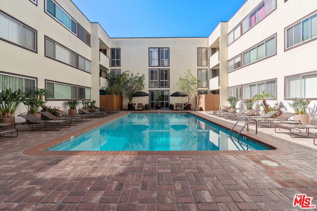 1015 North Kings Road, Unit 110 West Hollywood, CA 90069 - Photo 35 of 38 a view of a house with swimming pool and sitting area