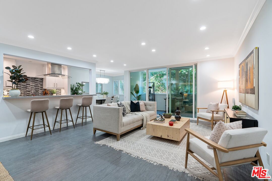1015 North Kings Road, Unit 110 West Hollywood, CA 90069 - Photo 38 of 38 a living room with furniture and a large window